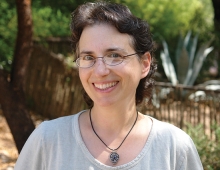 A picture of a woman, Laura Markowitz, with glasses smiling. 